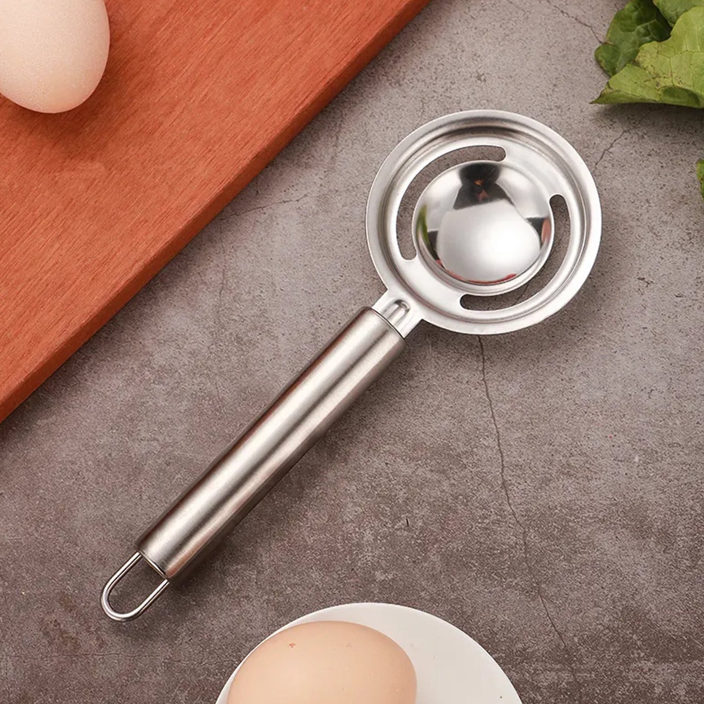 Kitchen tool for separating egg yolk and whites, stainless steel.