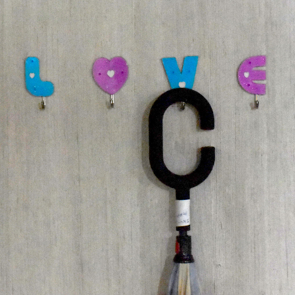 Adhesive hooks in love shape, ideal for home use.