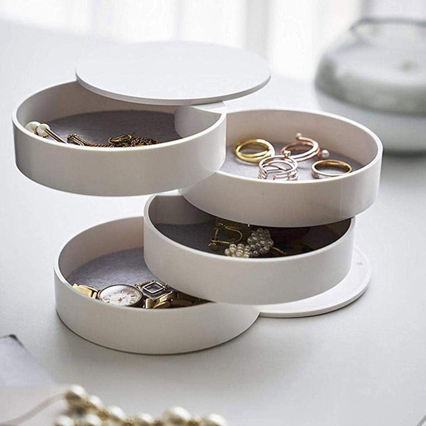 360-degree rotating jewelry box with mirror and multiple storage layers.