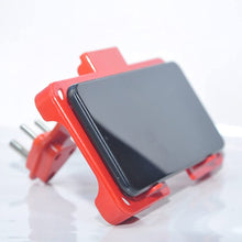 Wall-mounted mobile charging holder in red.