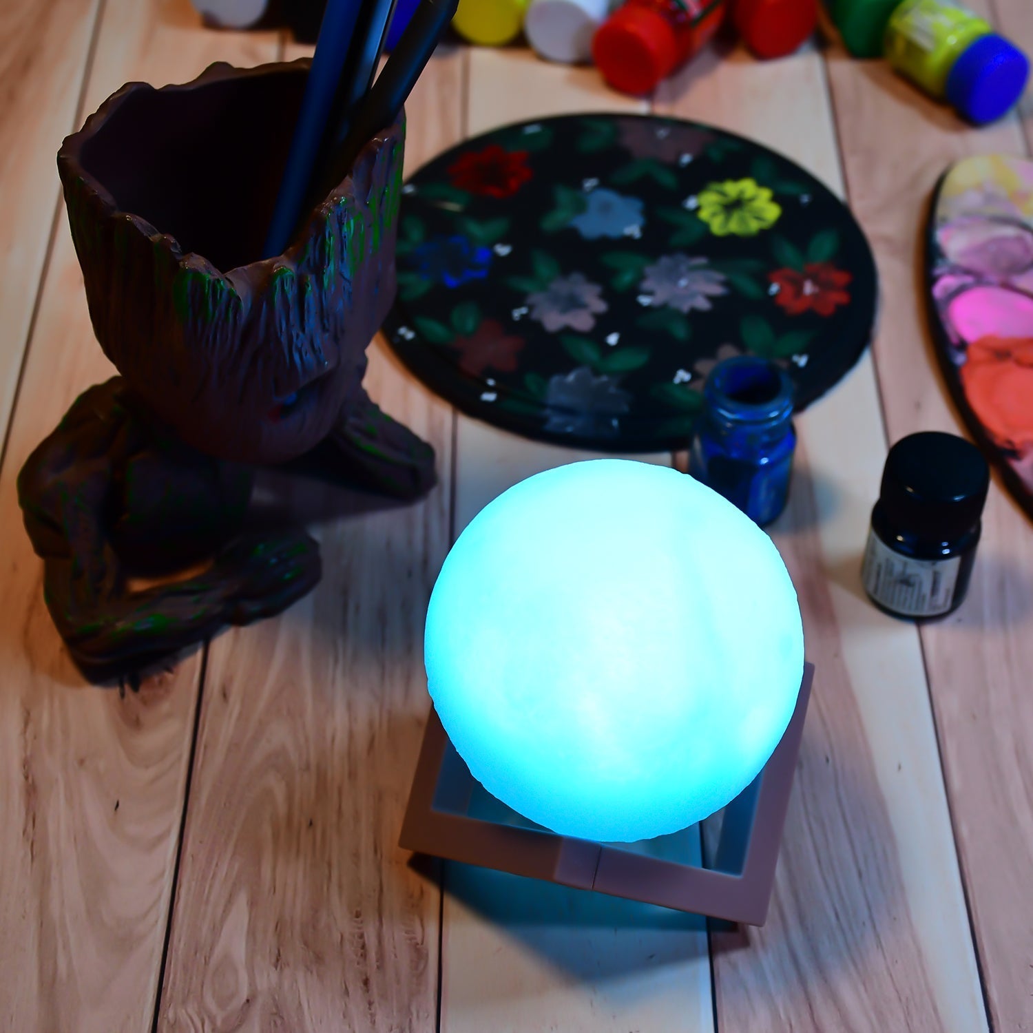 Blue moon lamp with a wooden stand, perfect for a cozy bedroom.