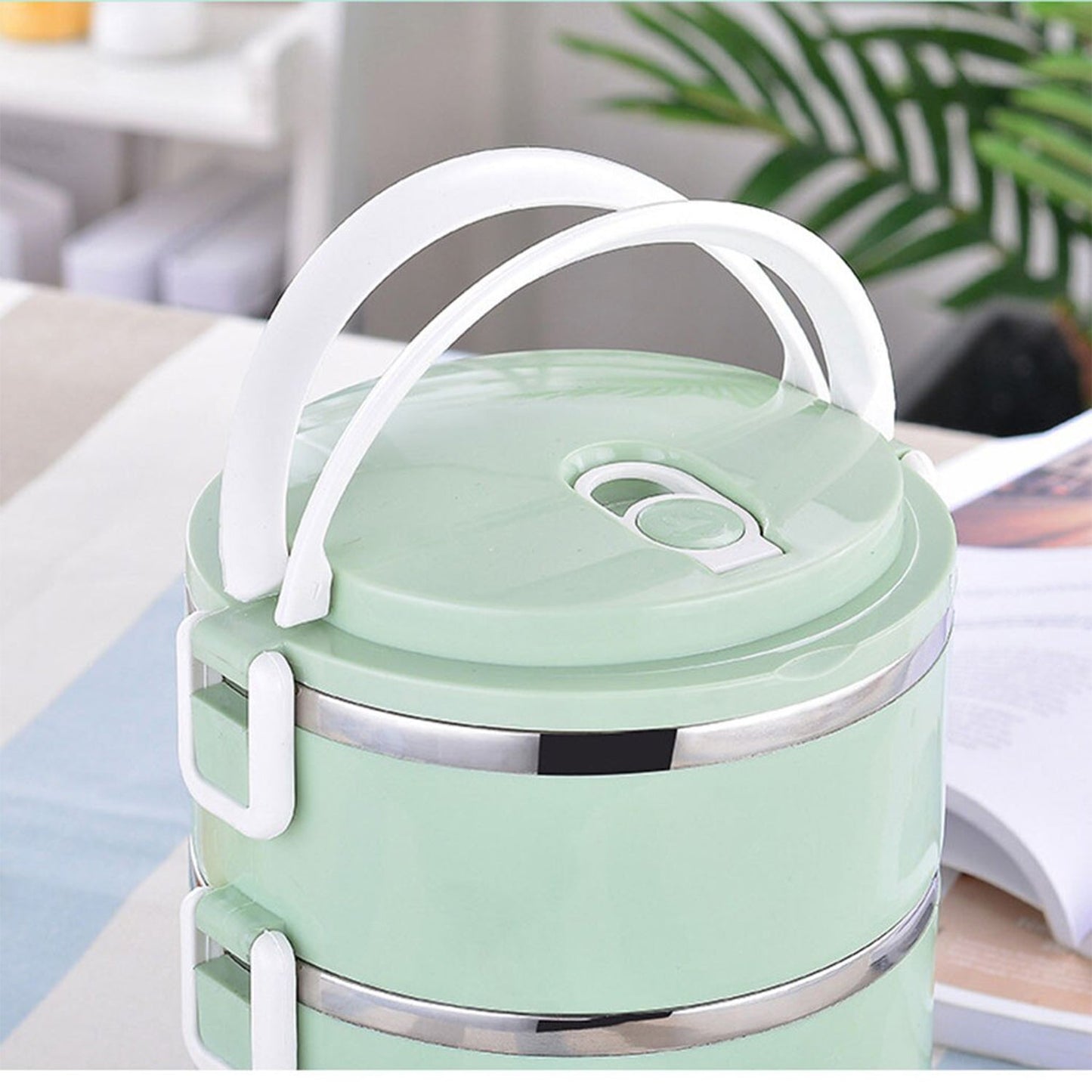 Two layer stainless steel lunch box for keeping food hot.